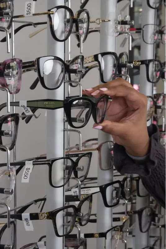 Choosing a frame from the display wall at Haven View Optics